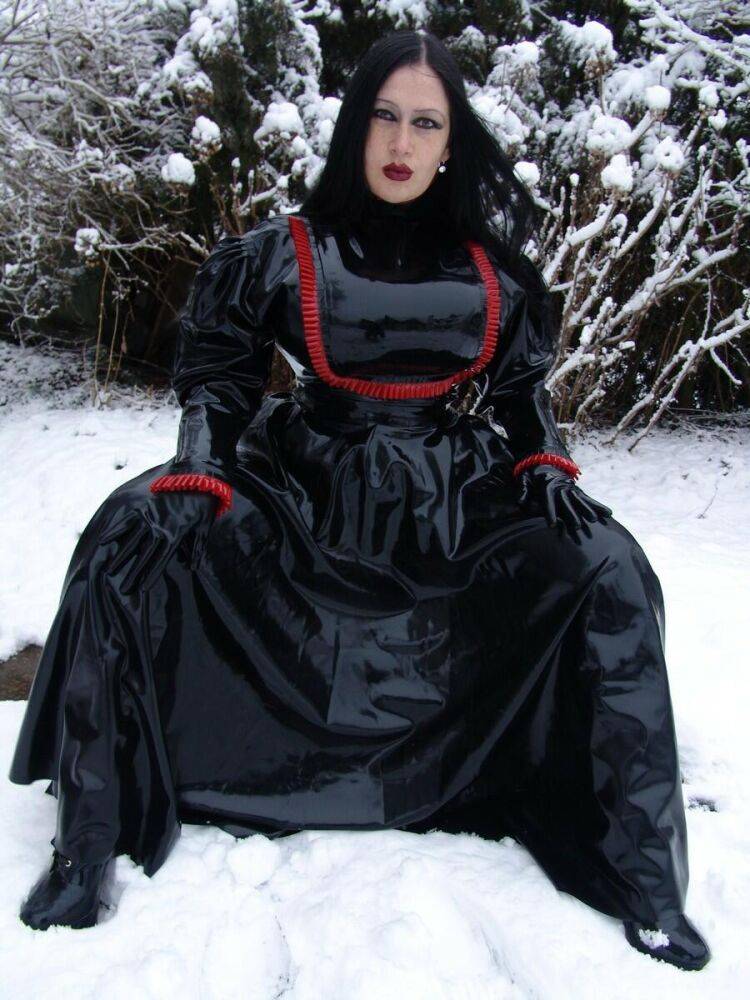 Goth woman Lady Angelina models a black latex dress on snow-covered ground - #8