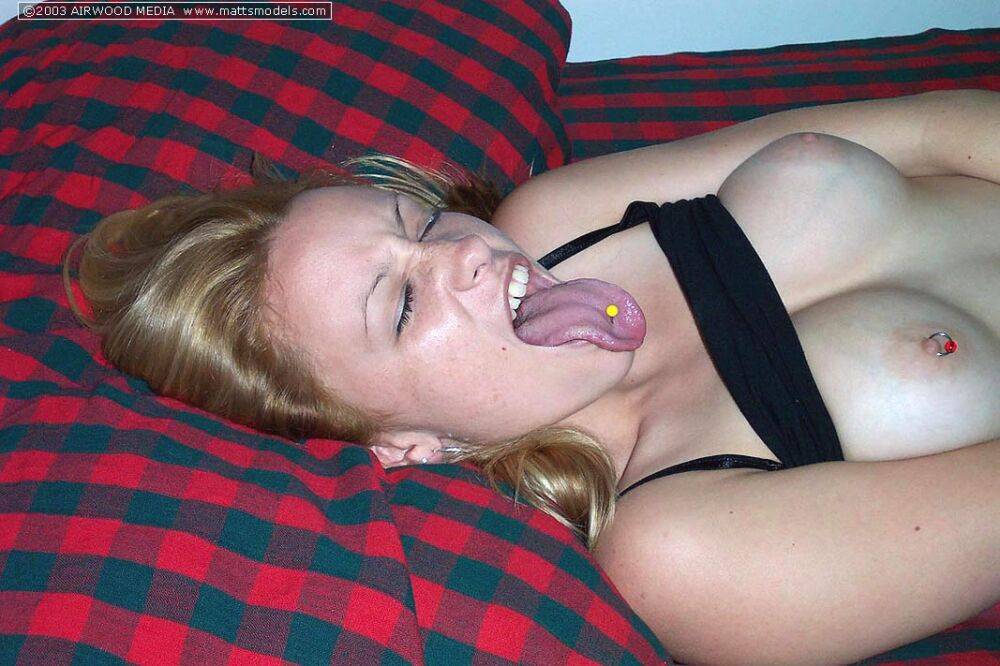 Young blonde Cali sticks out her pierced tongue during her first nude shoot - #4