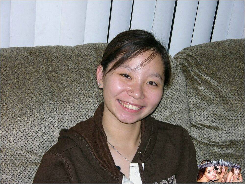 Barely legal Asian girl wears nothing more than a smile while showing her twat - #15