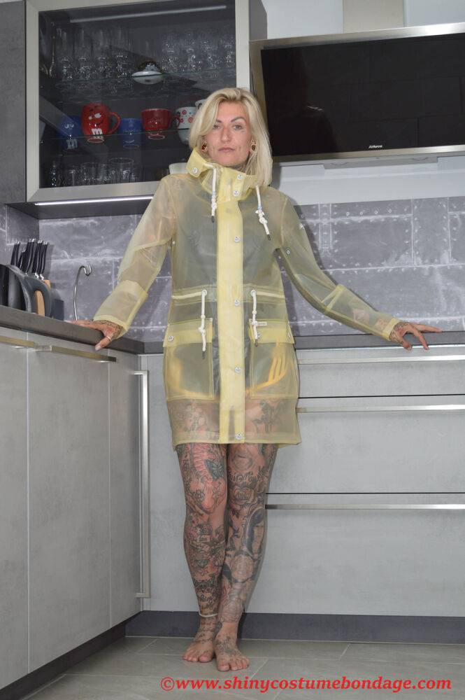 Tattooed blonde Miss Francine models barefoot in a raincoat over rubber wear - #8