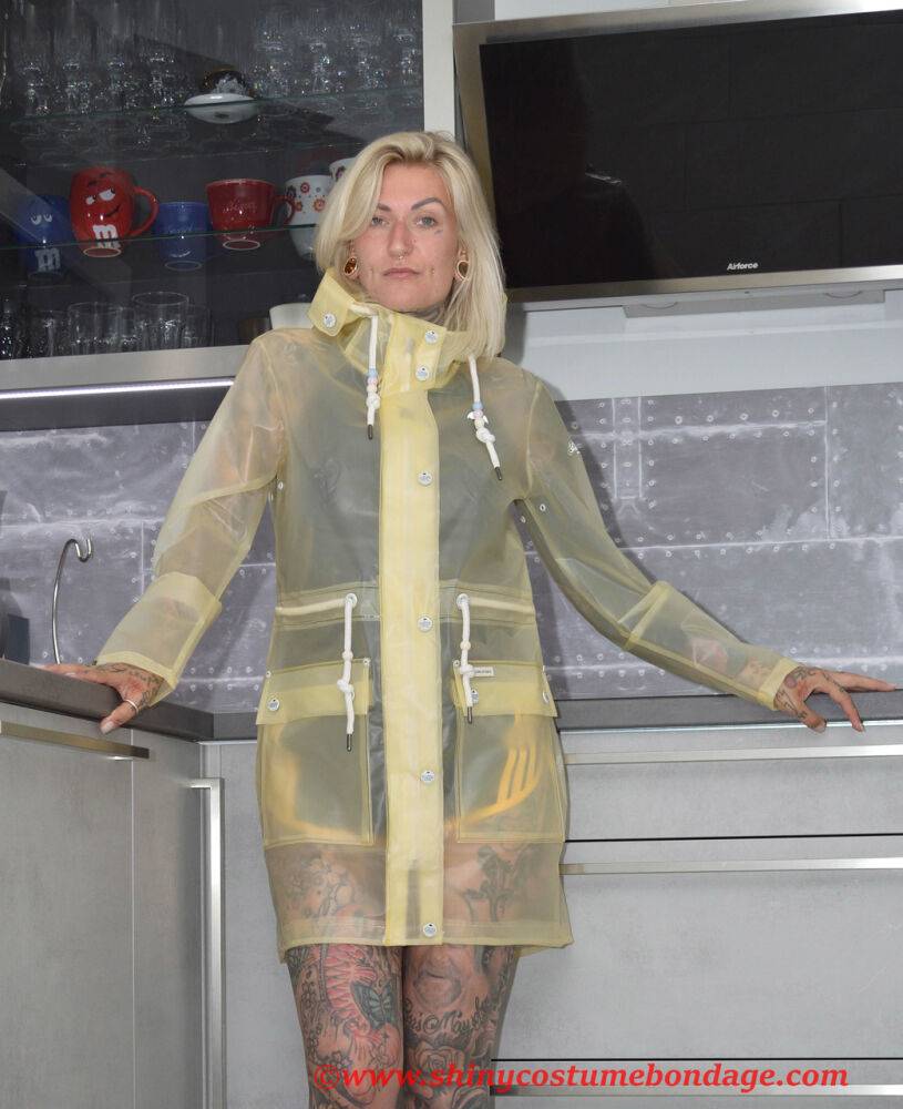 Tattooed blonde Miss Francine models barefoot in a raincoat over rubber wear - #7