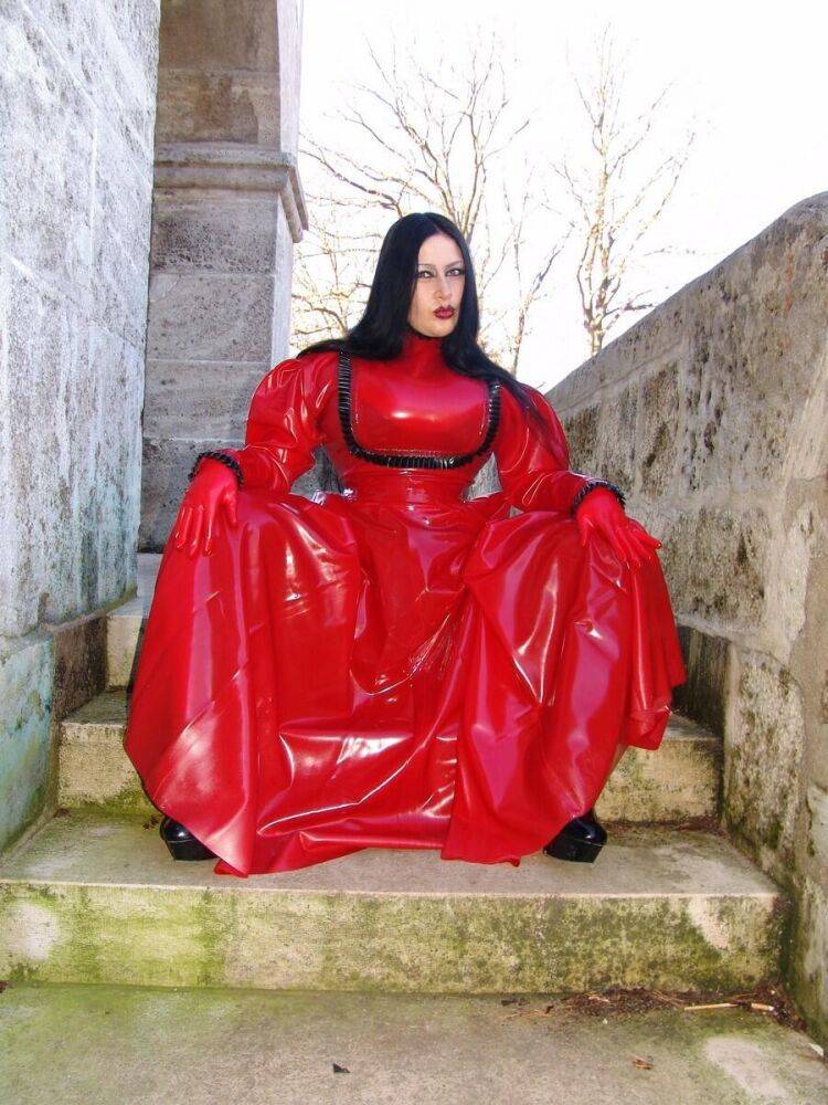 Goth woman Lady Angelina models a red latex dress during non-nude action - #7