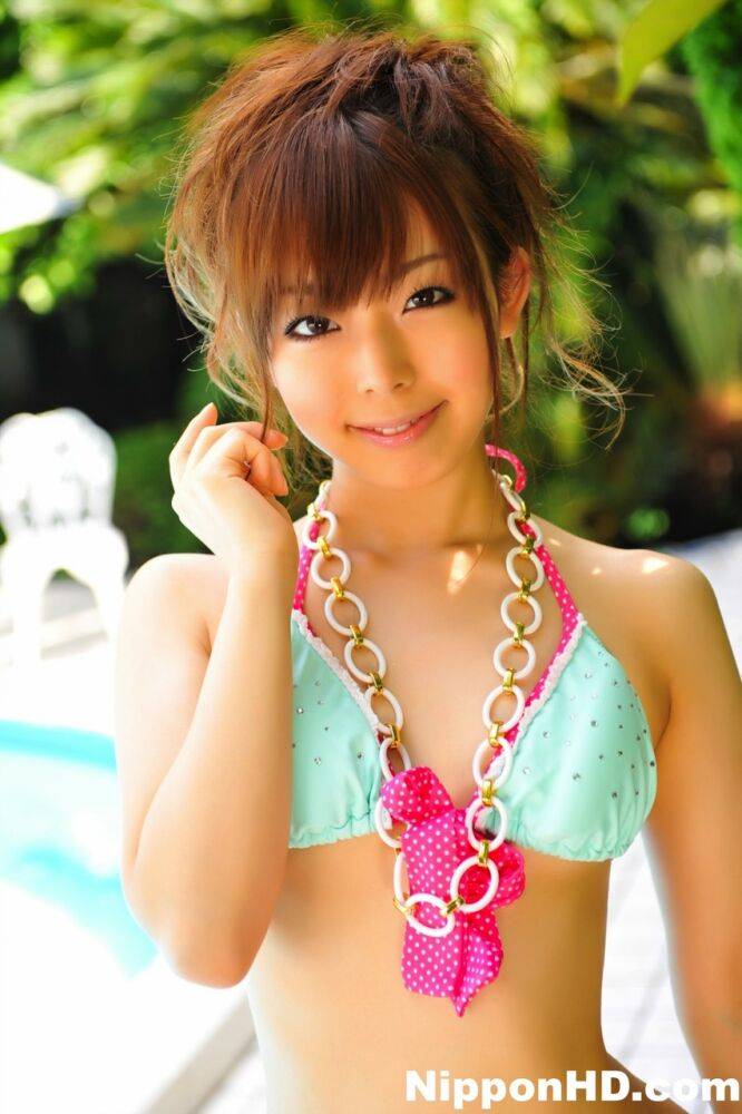 Adorable Japanese girl models a pretty bikini on a poolside patio - #1