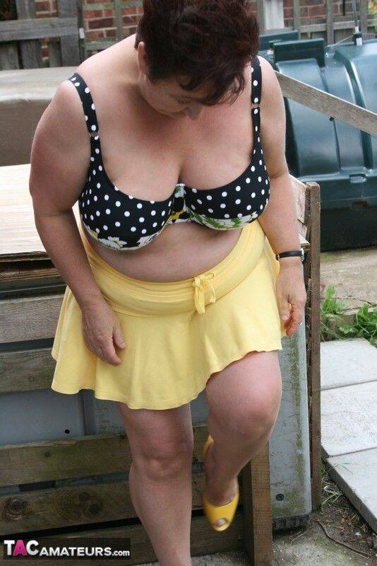 Thick older woman Kinky Carol models a bikini on patio stones - #11