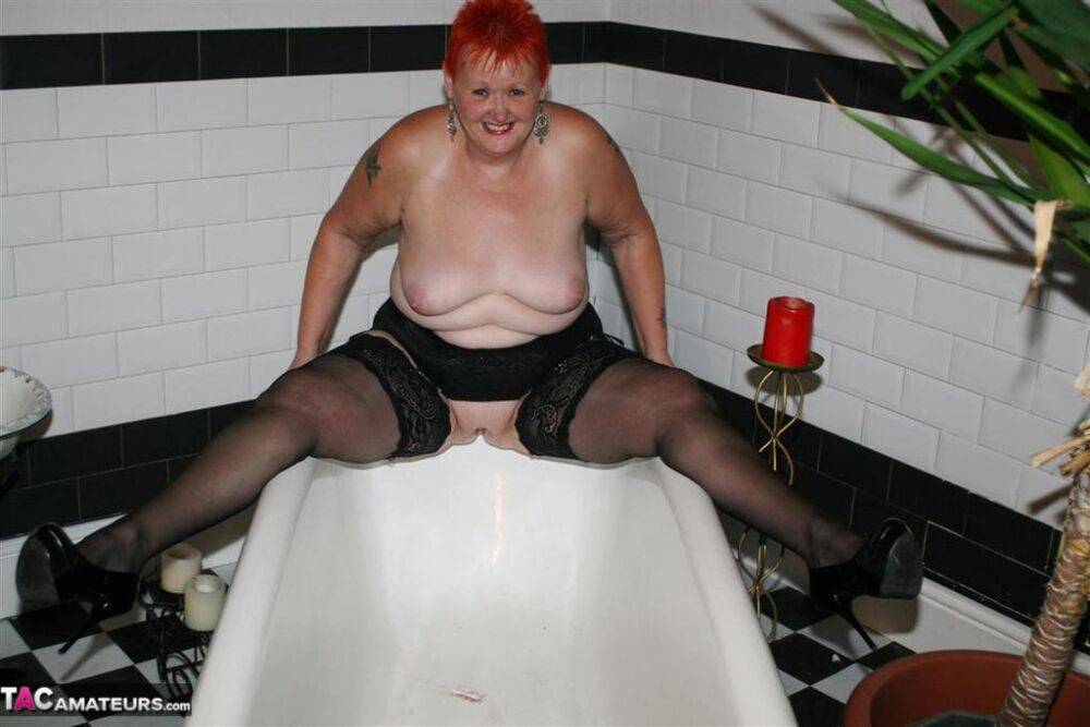 Older redhead Valgasmic Exposed models on the side of a claw tub in hosiery - #1