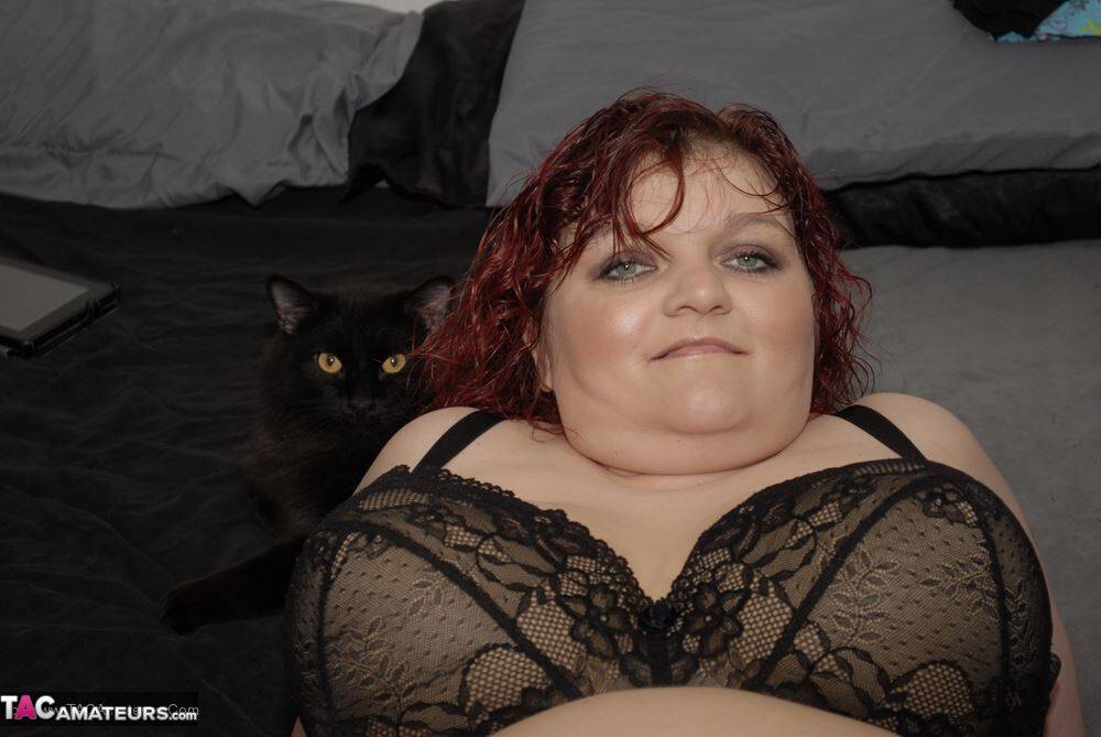 Redheaded BBW Black Widow AK models on her bed in a black bra and panty set - #4