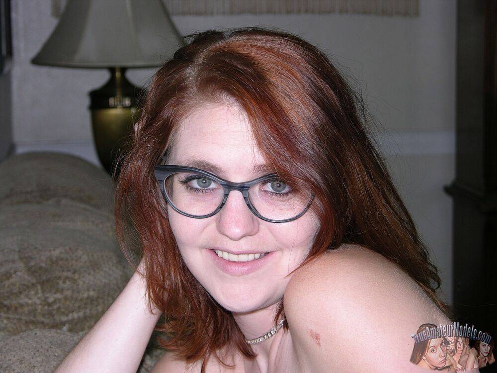 Young redhead with pierced nipples gets naked with her glasses on - #16