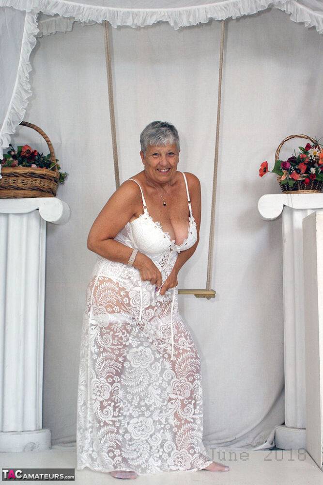 Short haired oma Savana models all white lingerie and hosiery on a swing - #11