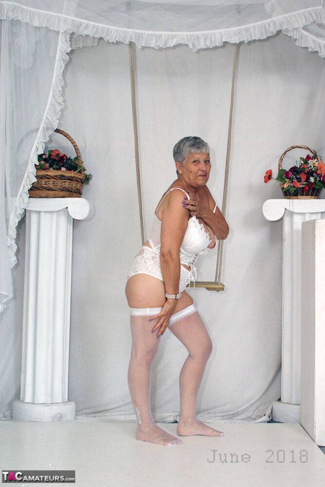 Short haired oma Savana models all white lingerie and hosiery on a swing - #1