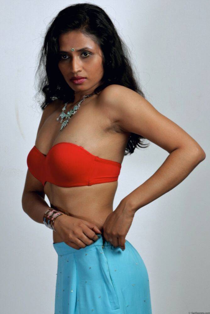 Indian woman models in a strapless bra and panties paired with red hosiery - #12