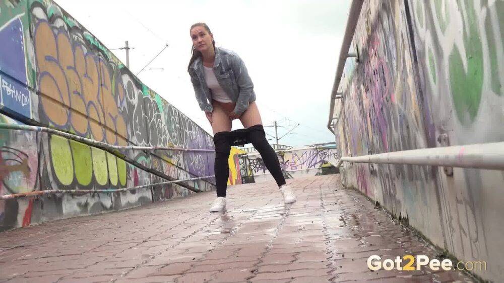 Solo girl Naomi Bennet pulls down black leggings to pee while on a footbridge - #8