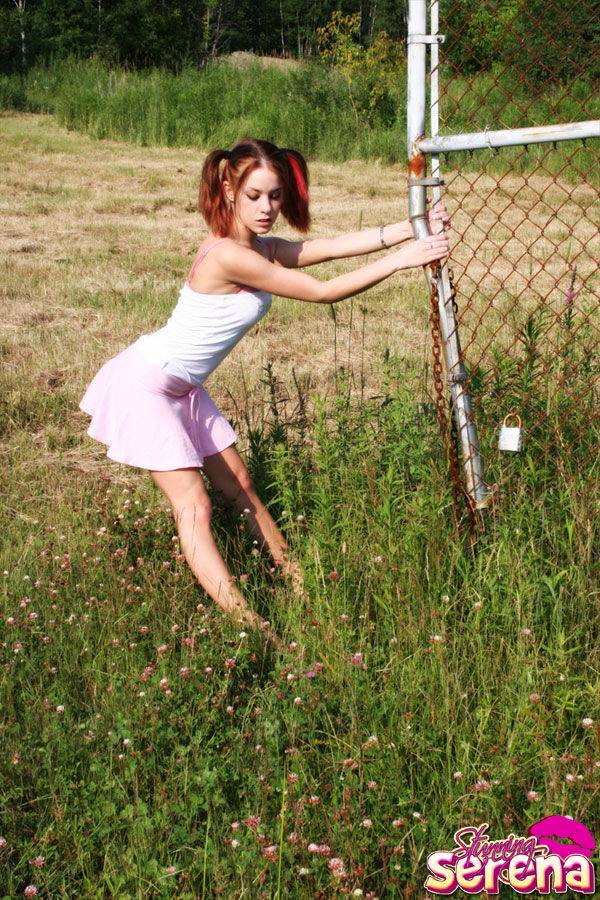Young redhead Stunning Serena exposes her ass by a chain link fence - #4