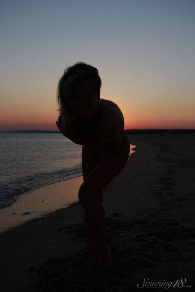 Young blonde Nicole V gets completely naked on a beach at sunset - #12