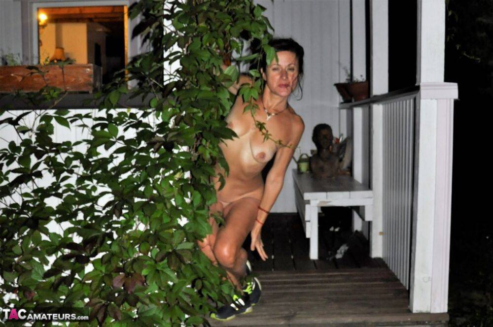 Older amateur Diana Ananta removes a long coat for nude poses on her porch - #11