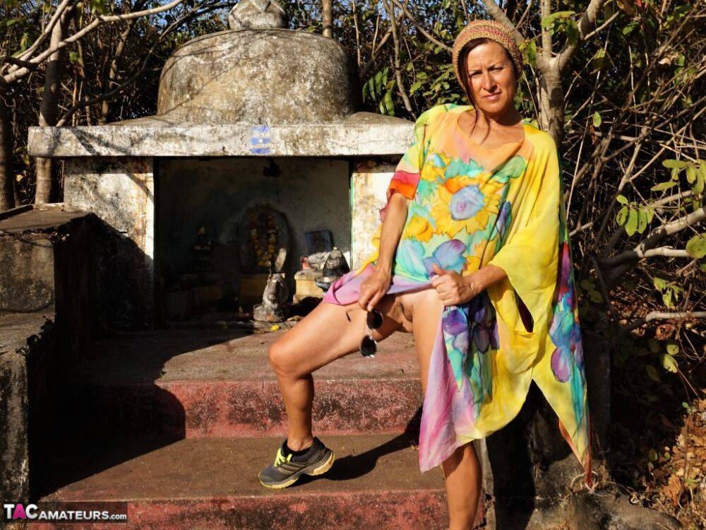 Older lady Diana Ananta exposes herself during a hike to a shrine atop a cliff - #8