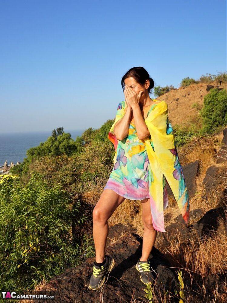 Older lady Diana Ananta exposes herself during a hike to a shrine atop a cliff - #7