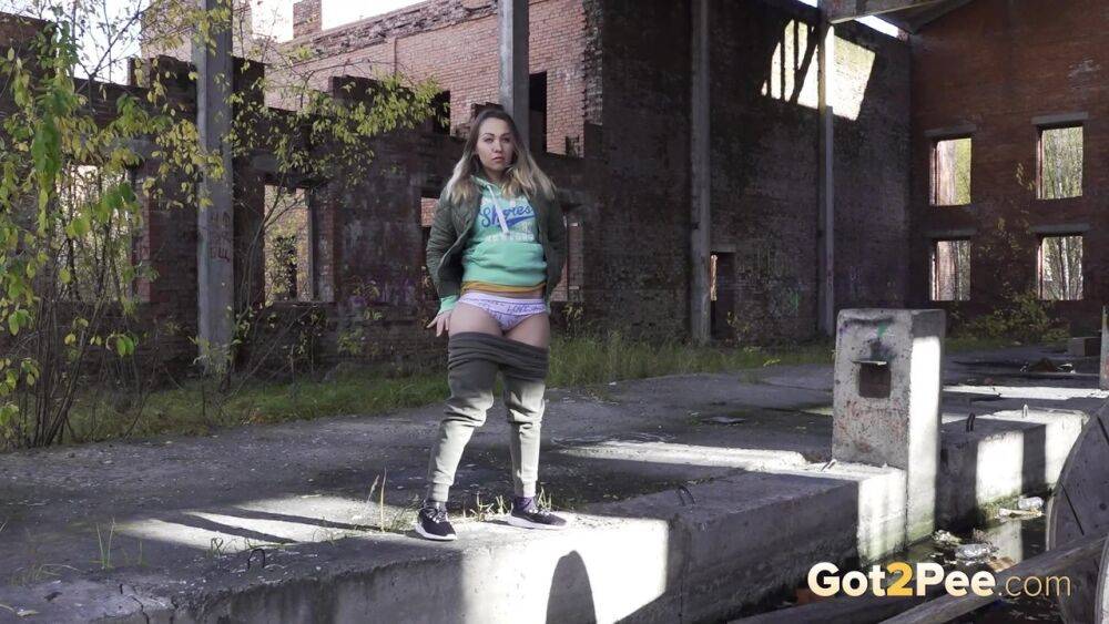 Caucasian girl Diana pisses on a sidewalk in a derelict environment - #8