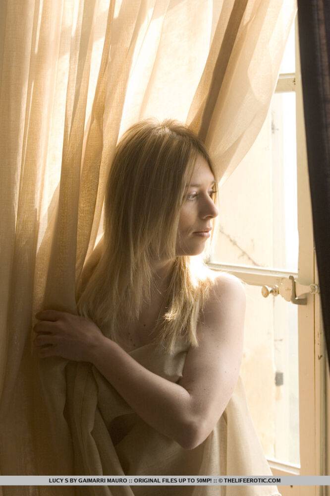 Pretty blonde Lucy S models completely naked on a window ledge - #1