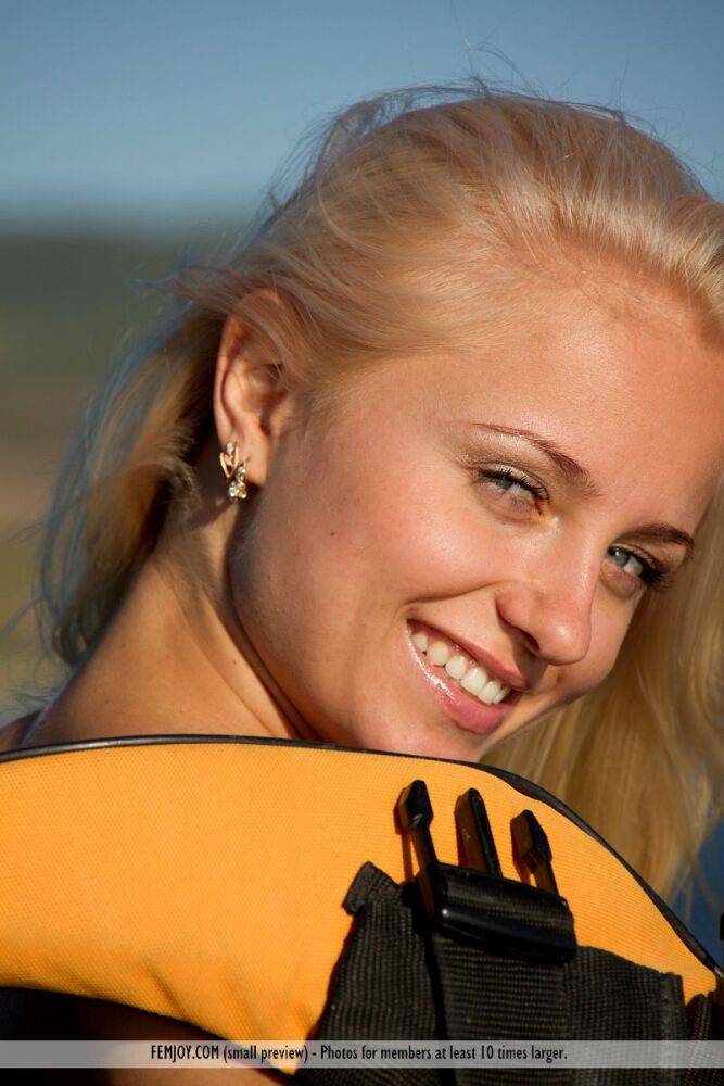 Blonde chick takes off her life jacket to pose naked on a boat - #9