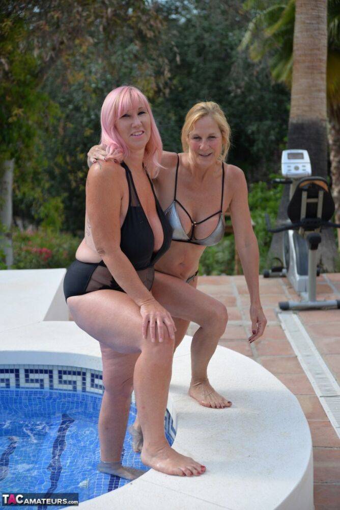Mature BBW Melody and her girlfriend walk hand in hand by a pool in swimwear - #2