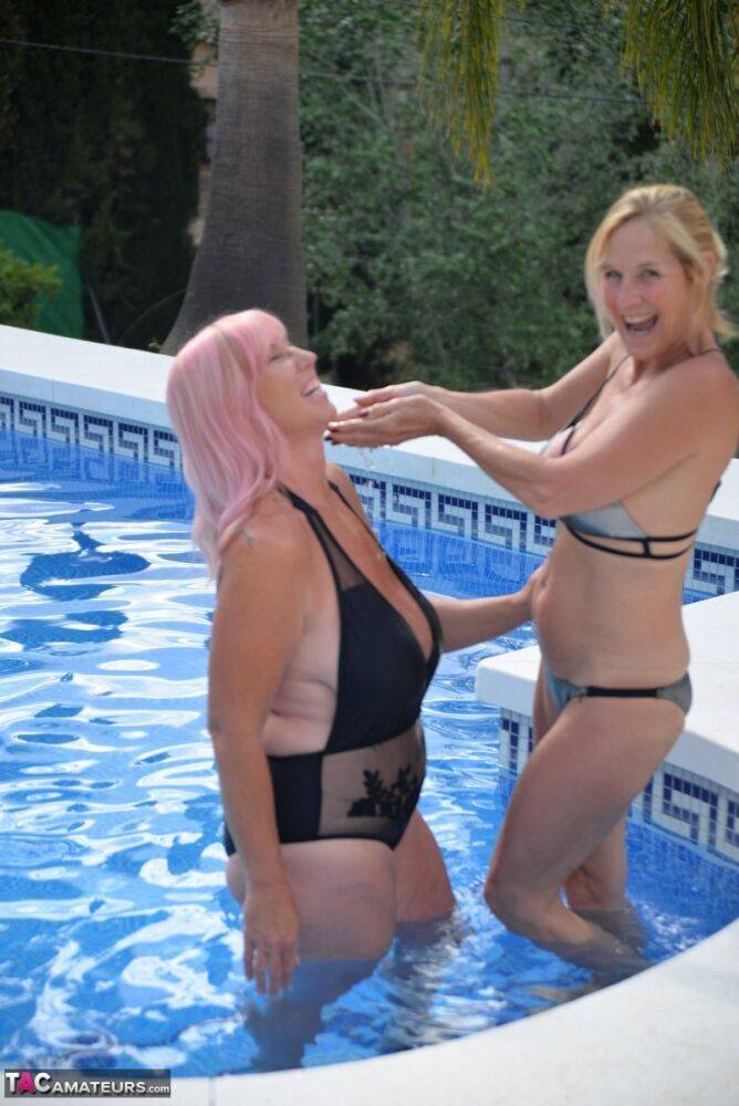 Mature BBW Melody and her girlfriend walk hand in hand by a pool in swimwear - #7