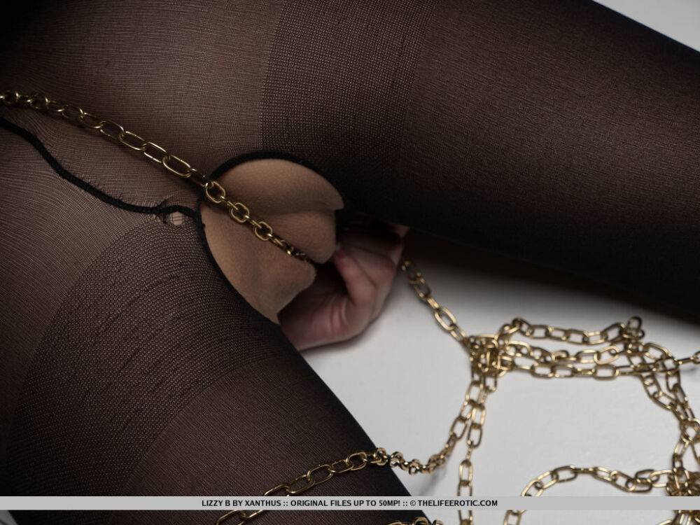 Lizzy B has her body tied up by golden chains and rubs it againts her - #1