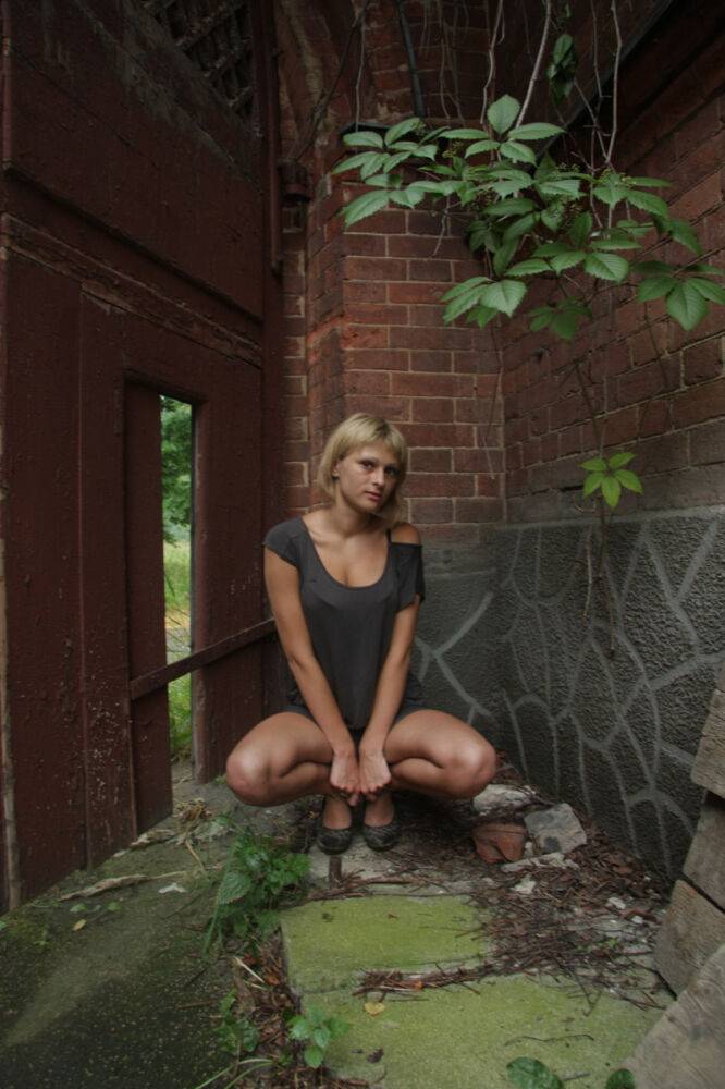 Blonde teen Santana uncovers her perky tits while undressing near a building - #14