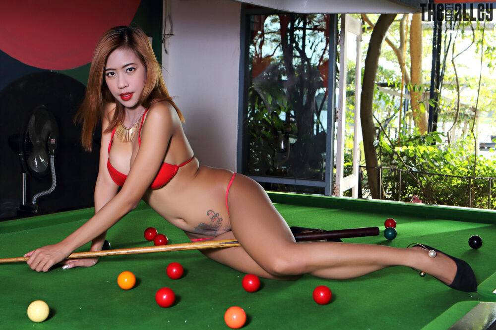 Redheaded Asian girl Linda removes her bikini to get naked on a pool table - #9