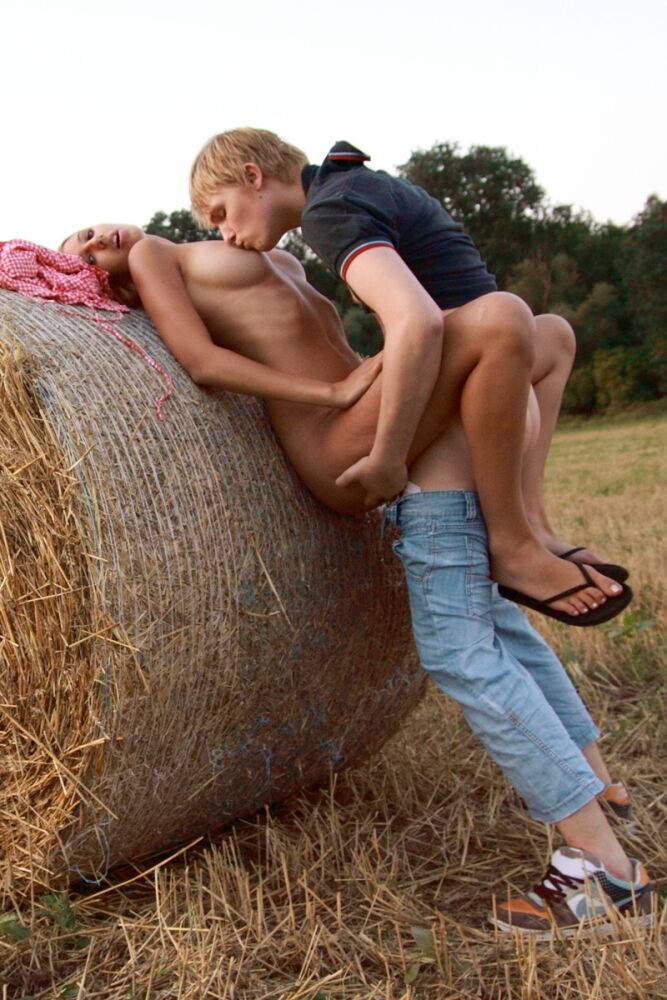 Young amateur and her boyfriend have sex up against a round bale in a field - #5