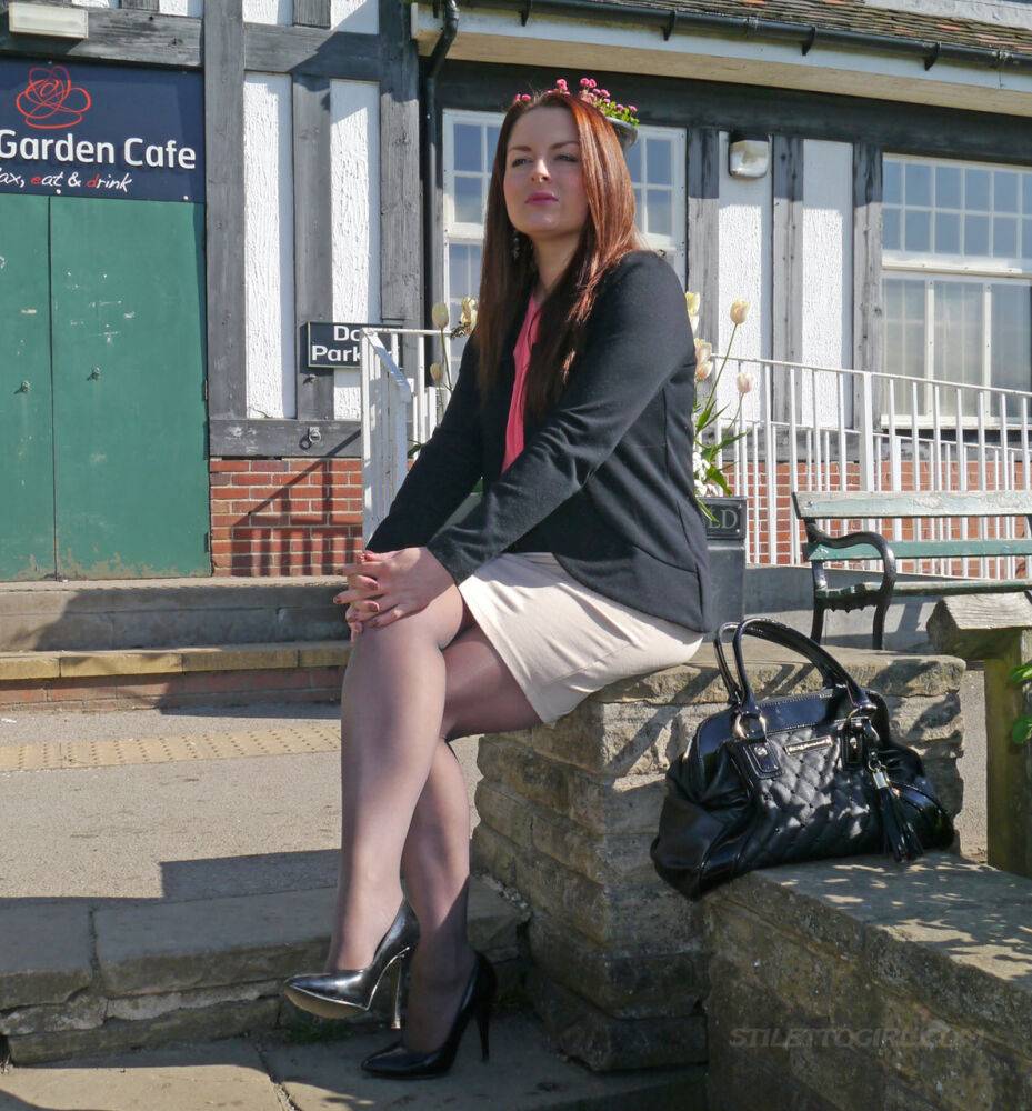 Clothed redhead Sara shows off her black heels on a sidewalk in hosiery - #8