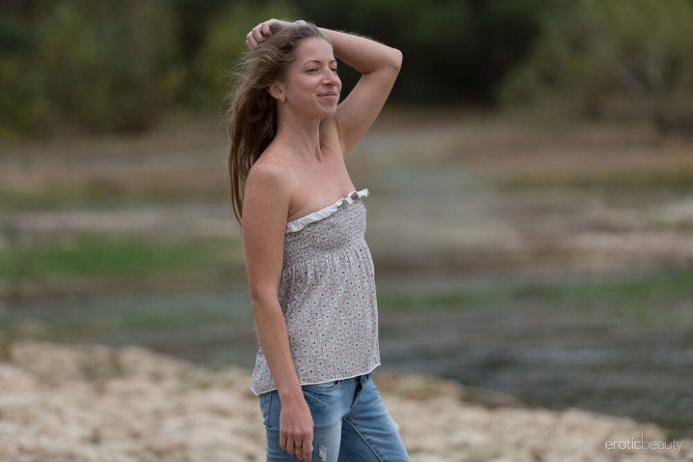 Teen model Mika A works free of faded blue jeans to get naked on a beach - #16