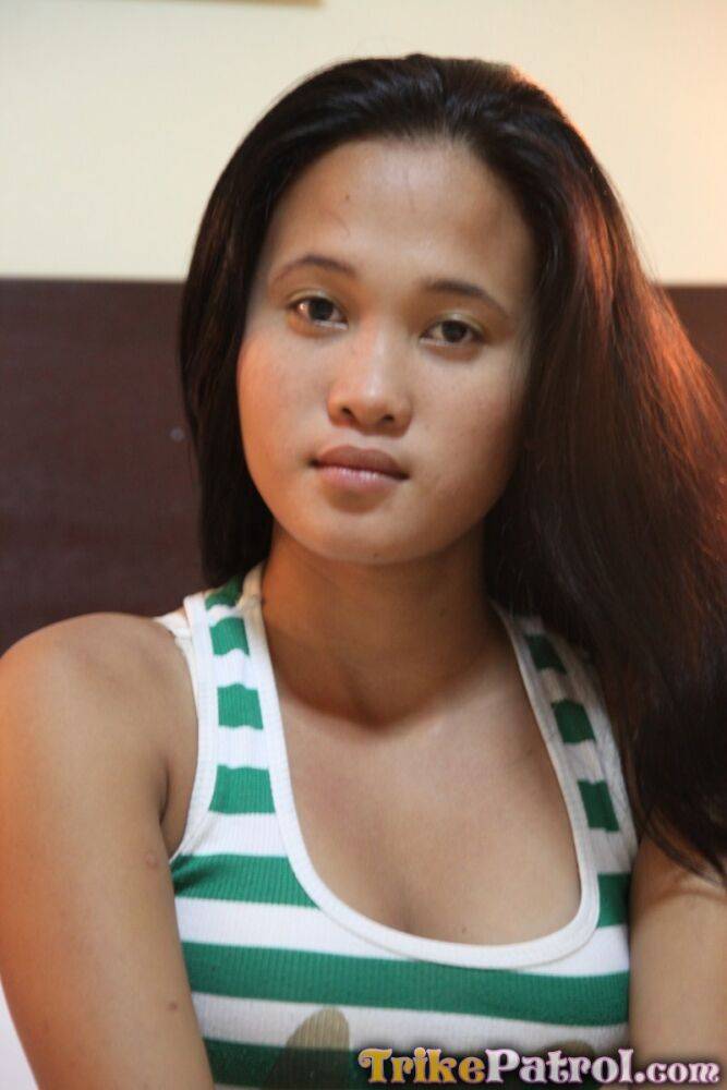 Young Filipina girl Ladylyne stands naked after getting undressed in a bedroom - #7