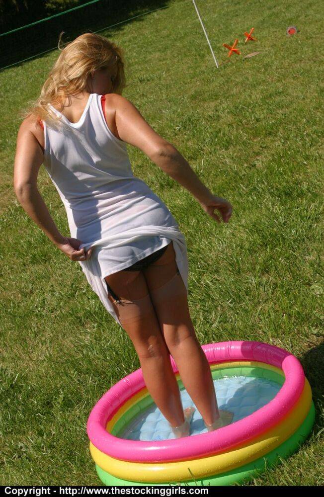 Amateur chick stands in a wading pool while baring her panties in nylons - #12