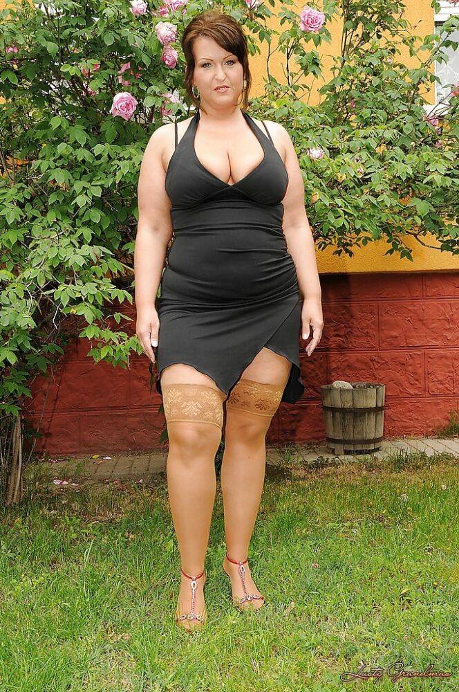 Seductive mature plumper in stockings taking off her dress outdoor - #4