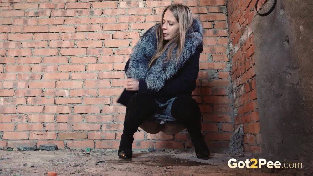 Distressed girl squats for an outdoor piss while wearing a heavy winter coat - #13