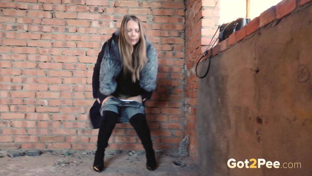 Distressed girl squats for an outdoor piss while wearing a heavy winter coat - #9