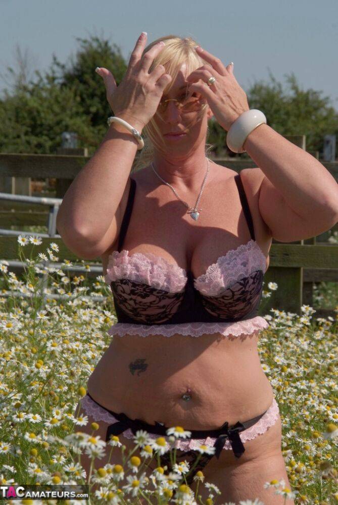 Overweight blonde Melody uncups her large boobs in a field of wild flowers - #8