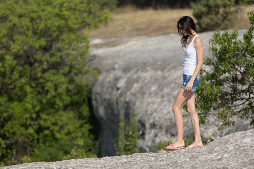 Slim brunette Adel Morel gets totally naked atop weather worn rock - #14