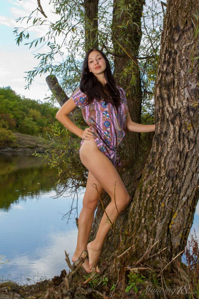 Barely legal brunette Gratidia N gets totally naked next to calm waters - #14