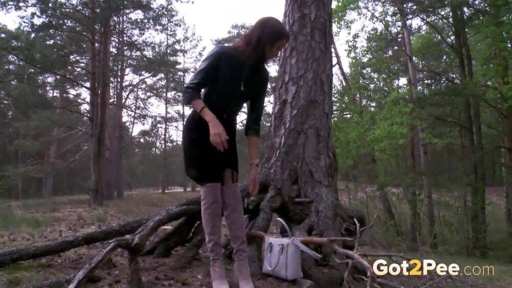 Solo girl Kristina K squats for a piss by a tree in OTK boots and nylons - #11