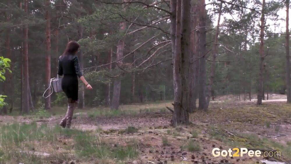 Solo girl Kristina K squats for a piss by a tree in OTK boots and nylons - #8