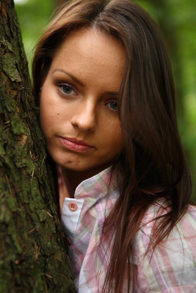 Young girl poses in the nude for the first time while in a forest - #9