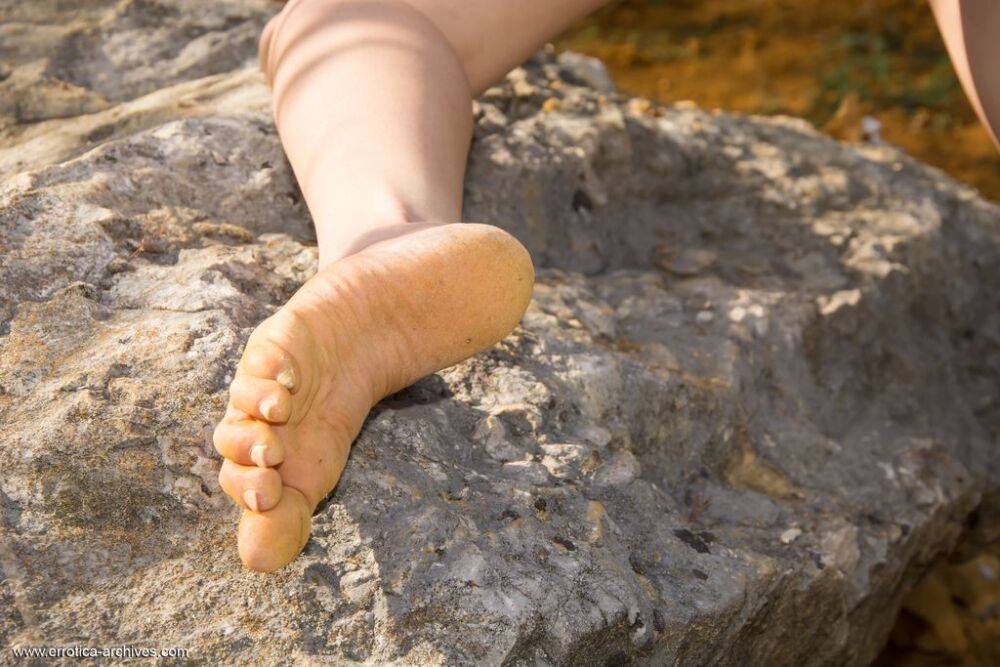 Teen model Rebecca Volpetti poses completely naked on a boulder upon a hill - #14