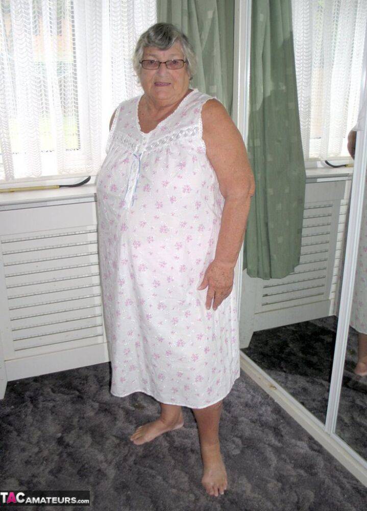 Old woman Grandma Libby grabs her fat roll after getting naked on a bed - #1