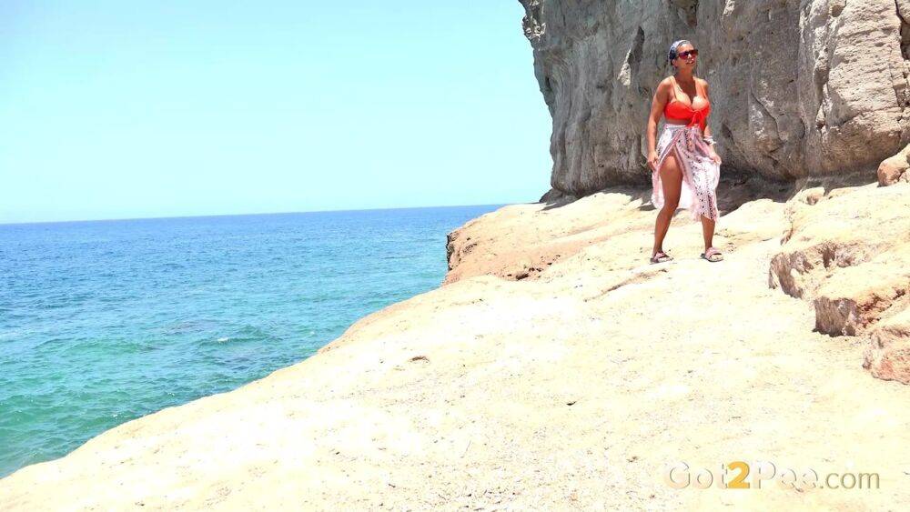 Caucasian girl Chloe Lamour takes a piss while walking upon a seaside cliff - #13