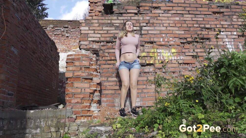 White girl ducks behind an old building to take an urgent piss - #15