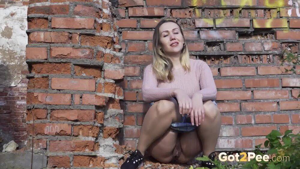 White girl ducks behind an old building to take an urgent piss - #8