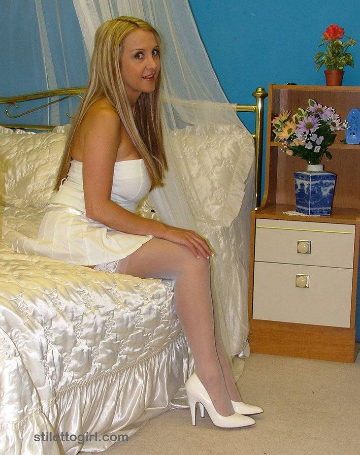 Pretty girl with blonde hair shows off her white pumps in white stockings - #16