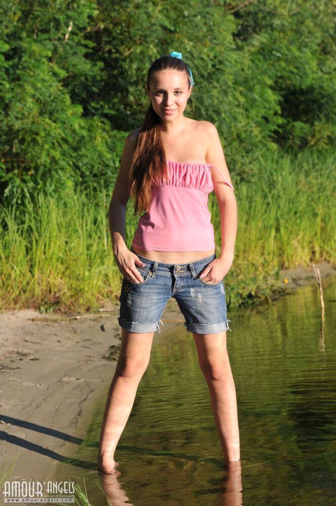 White teen takes off denim shorts to showcase her bald pussy on beach sand - #8