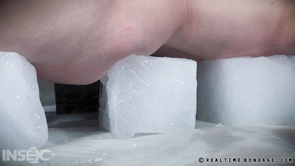 Tied up white girl Kel Bowie is lies on ice blocks while being doused with wax - #6